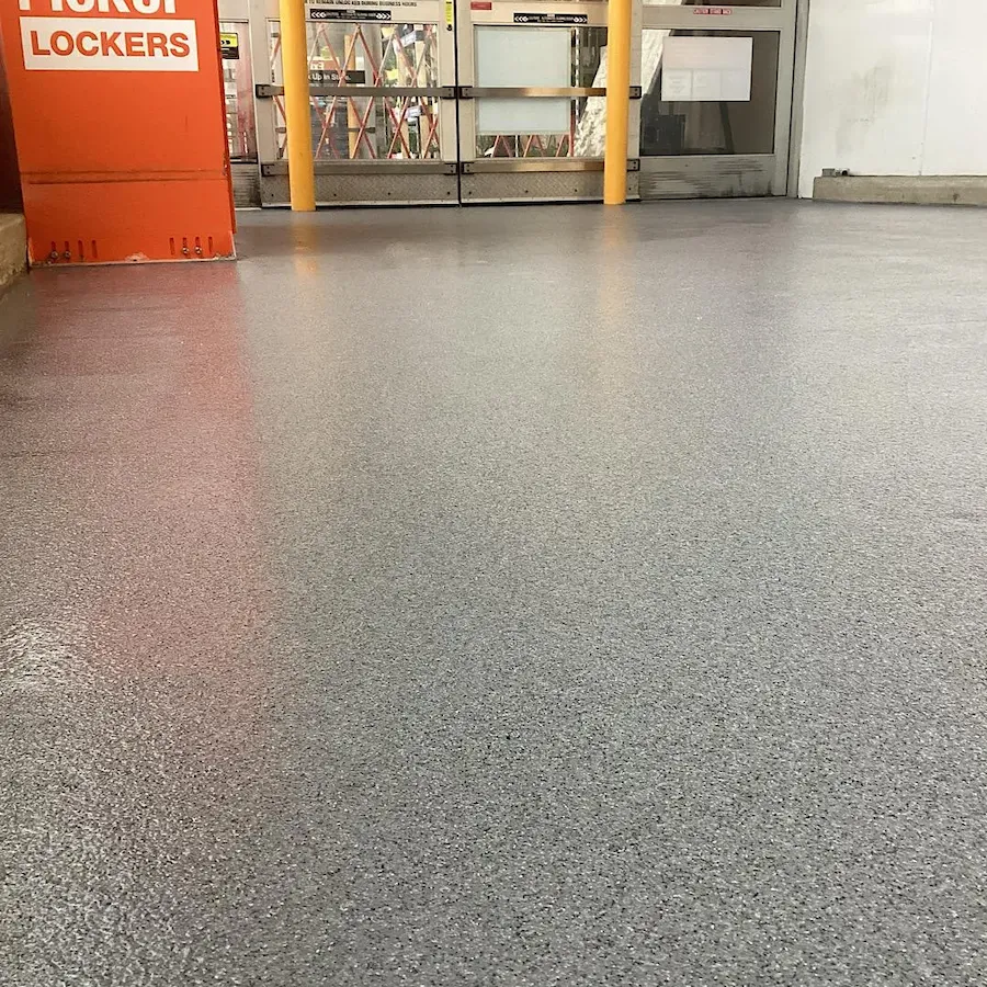 Close-up of anti-slip texture on grey epoxy floor for industrial safety.
