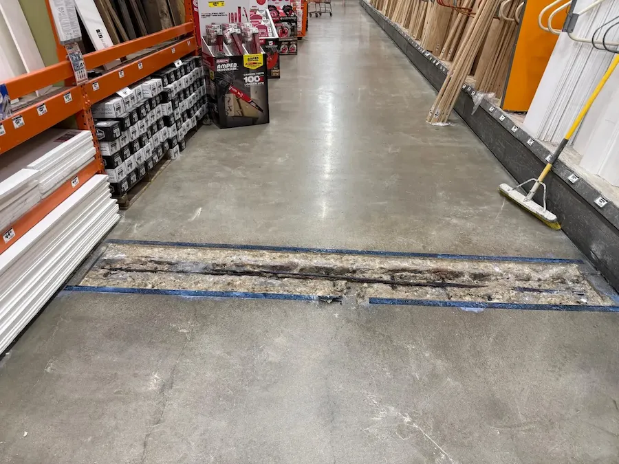 Professional cleaning of control joints in a warehouse floor.