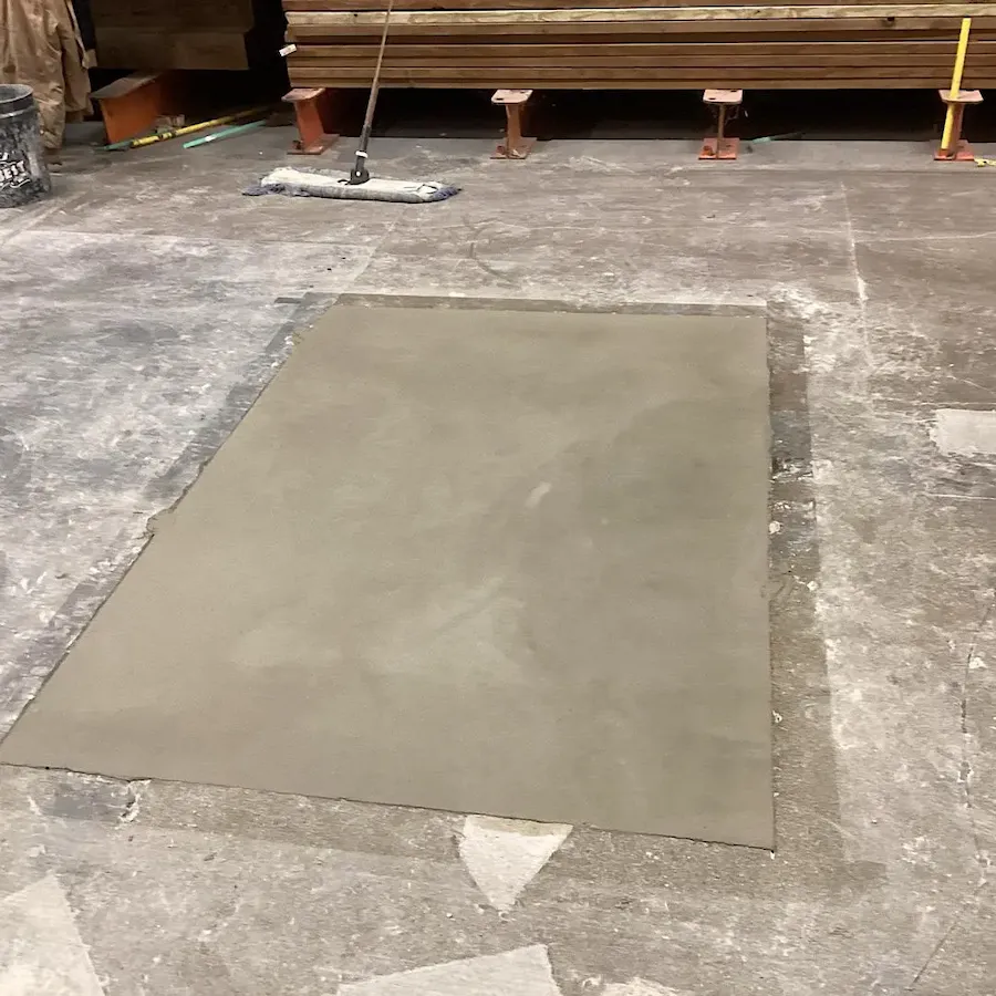 Final finish of concrete floor repair in a warehouse area, high-quality professional work.